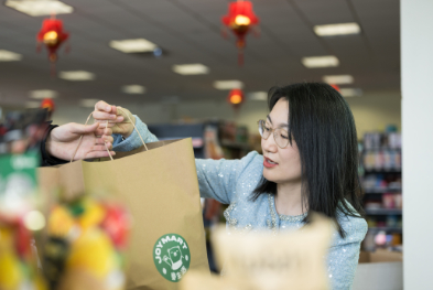 Yaofang (Vicki) Liang serving a customer.