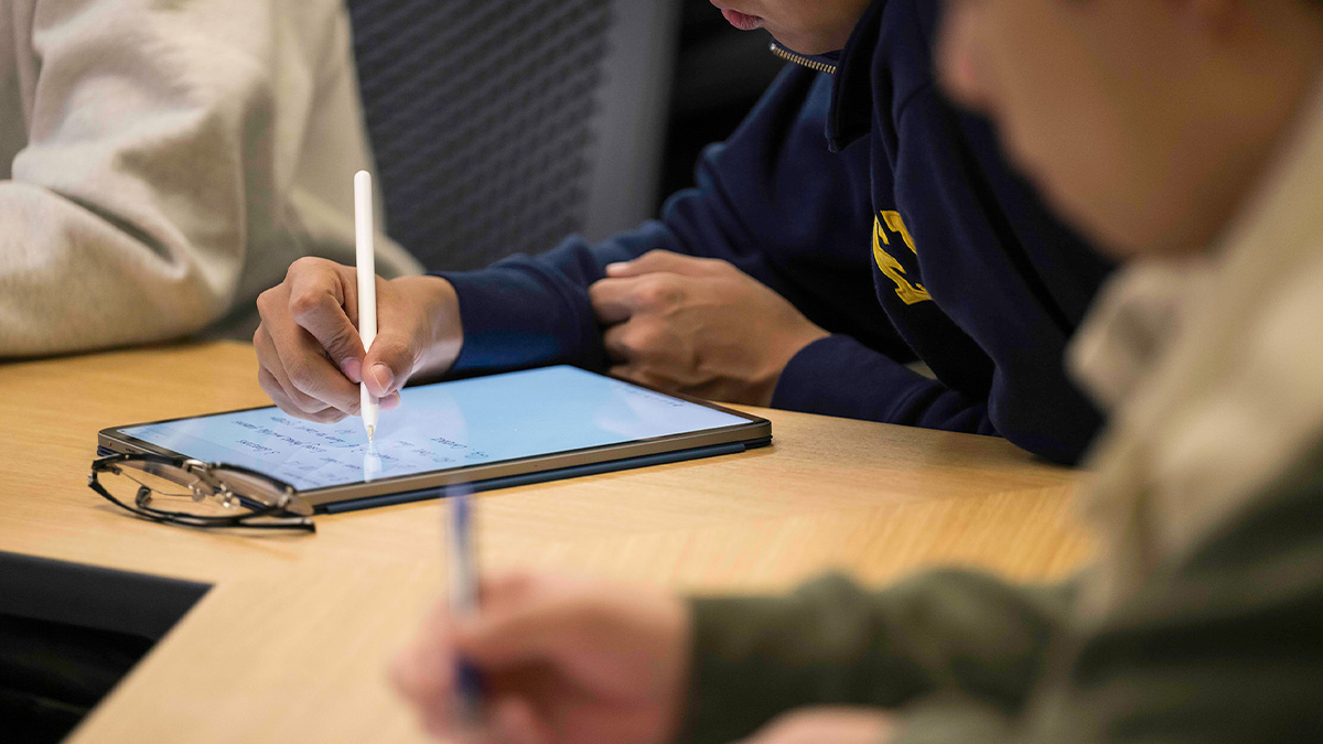 Student taking notes on an electronic device during class. (URochester photo / J. Adam Fenster)