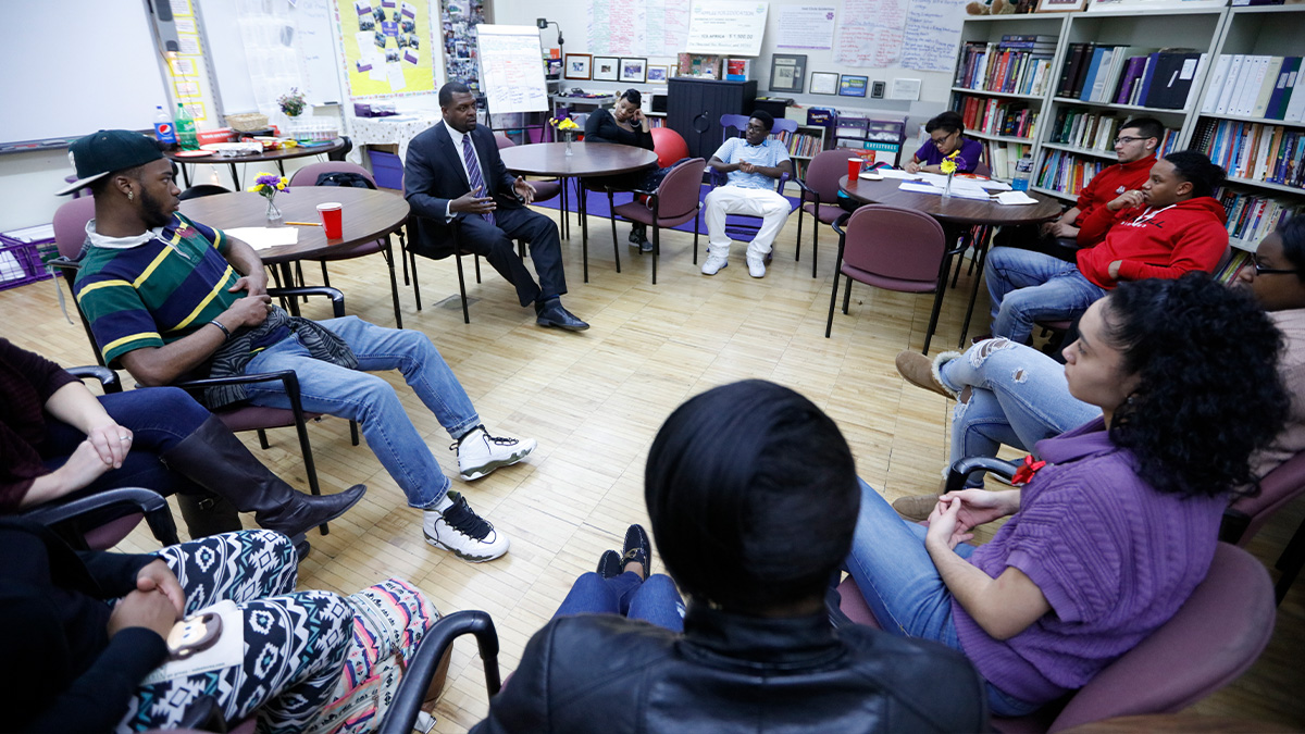 Shaun Nelms, former East EPO superintendent, meets with his Family Group, a small cohort of about 10 East scholars who gather daily with their “carents”—a pair of teachers or staff members who relate to the group as “caring parents.” (University of Rochester photo / Matt Wittmeyer)