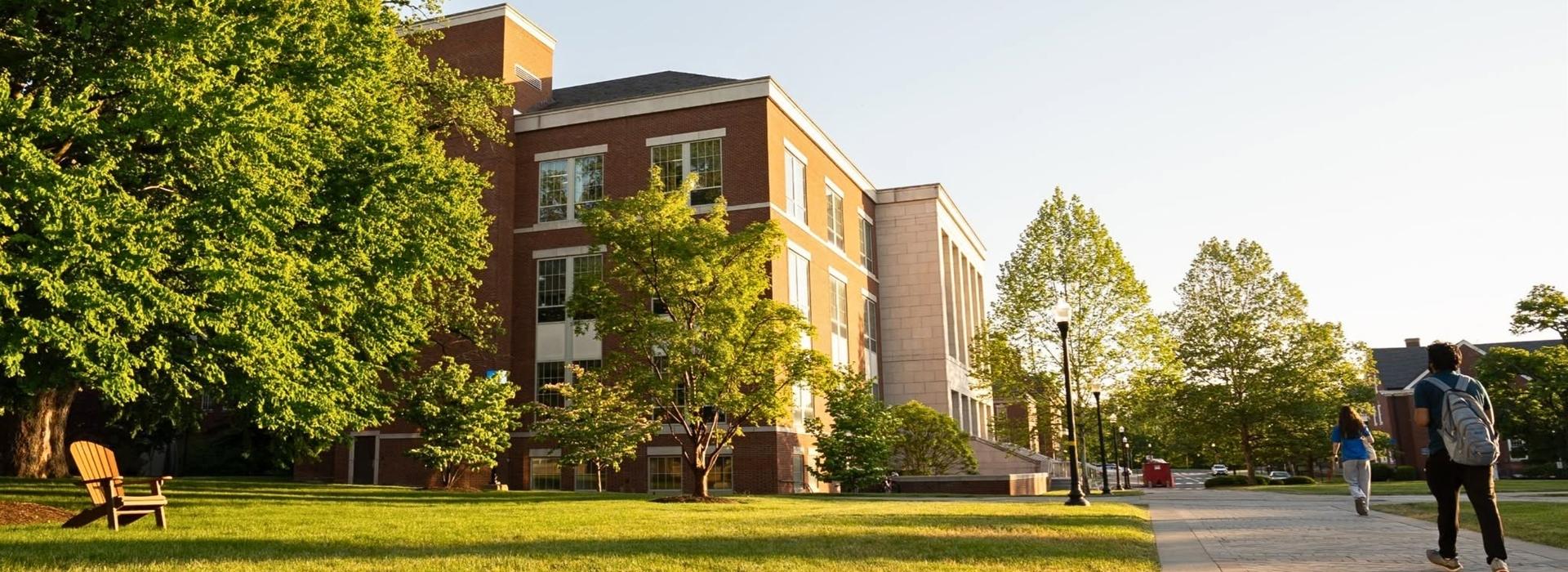 Students walking on the sidewalk outside of LeChase Hall.