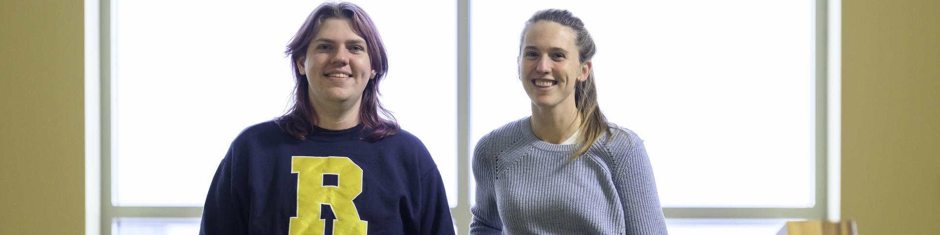 Two students standing in the stairwell of LeChase Hall