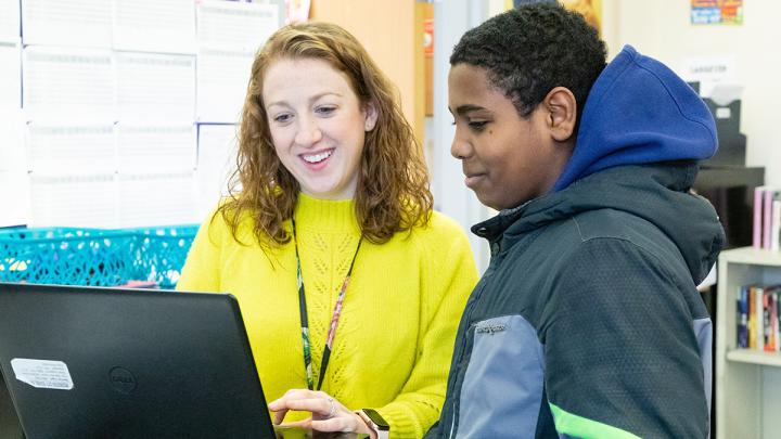 teacher looking at computer with student in RCSD