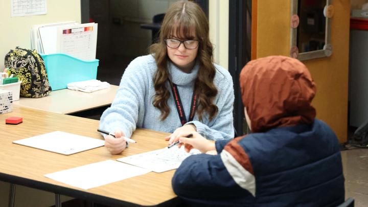 Tia Clark working with a Hilton student.