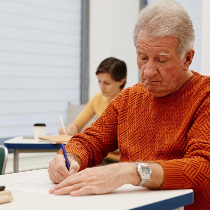 Older man doing class work