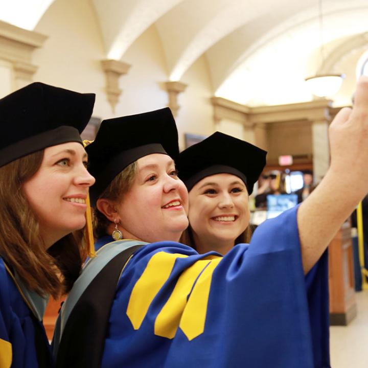 2023 Warner graduates taking a selfie at the Warner School ceremony.