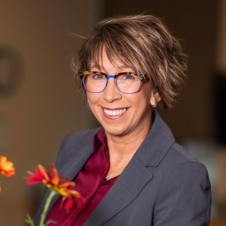 April Luehmann portrait, smiling at the camera.