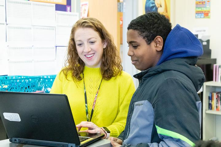teacher looking at computer with student in RCSD