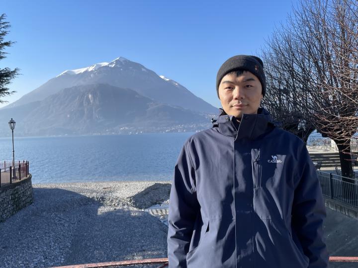 Chad/Yunxiang Chen standing in front of a mountain.