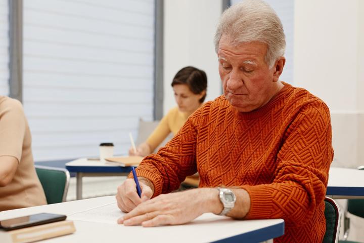 Older man doing class work